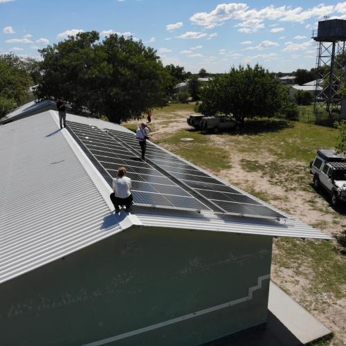 Das Team der THI untersucht die neue installierte PV-Anlage auf dem Dach der Tsumkwe Secondary School